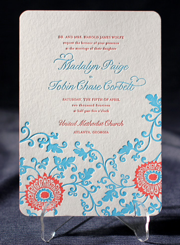 Monogram invites have initials of the couple designed cut and pasted on the